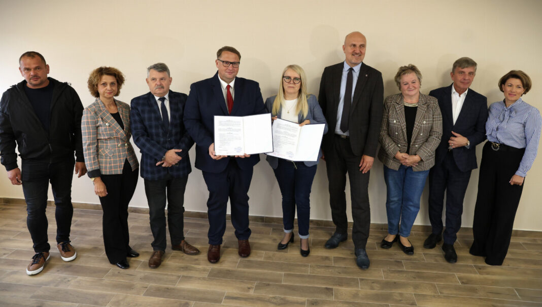 Grupa osób podczas uroczystości podpisania umowy na remont drogi wojewódzkiej 758